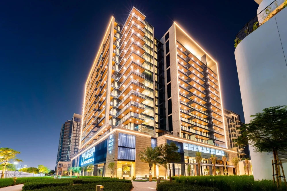 399 Hills Park towers by National Properties lit at night in Dubai Hills Estate