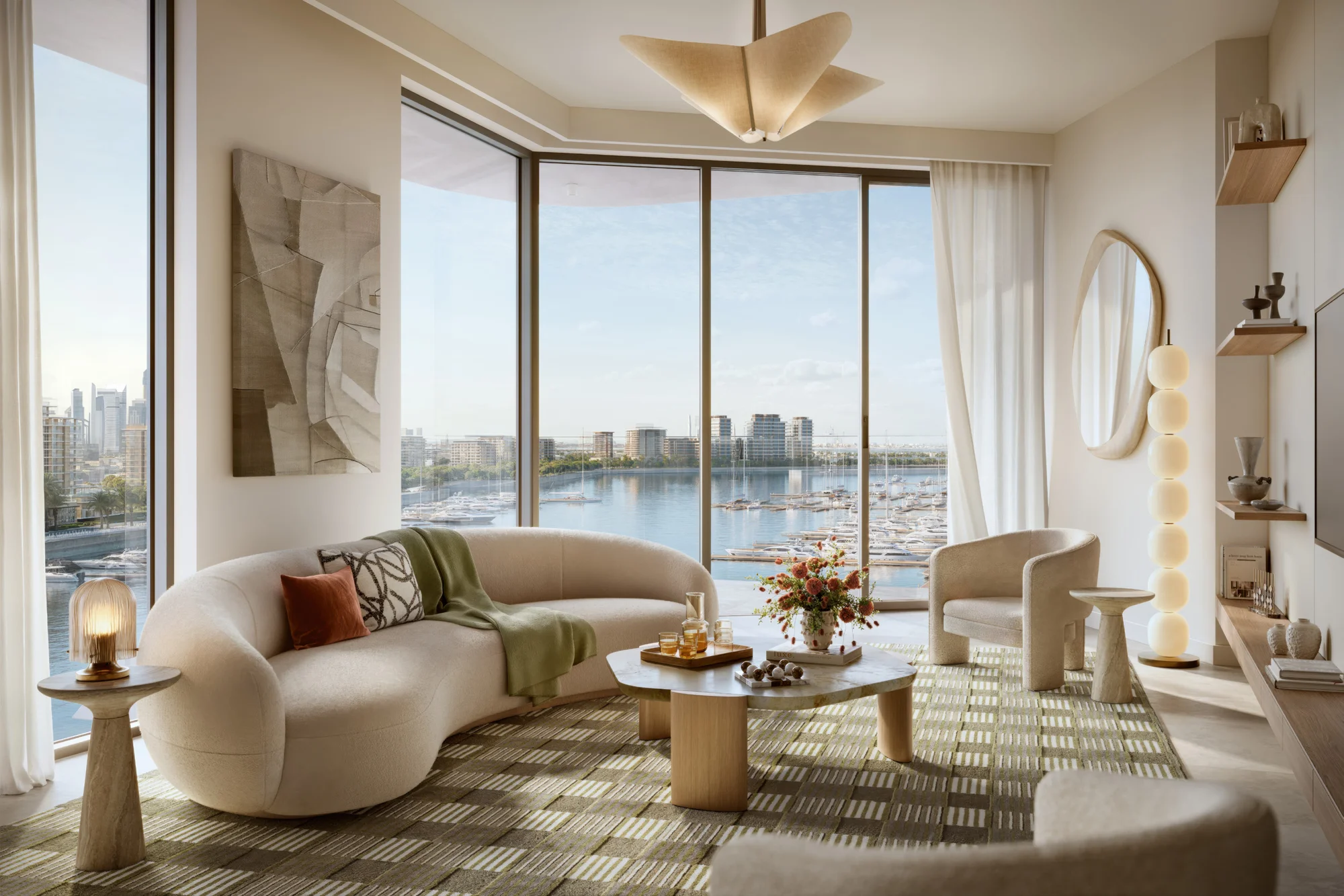 Fior 1 living room with a curved sofa and floor-to-ceiling windows looking over the yacht marina