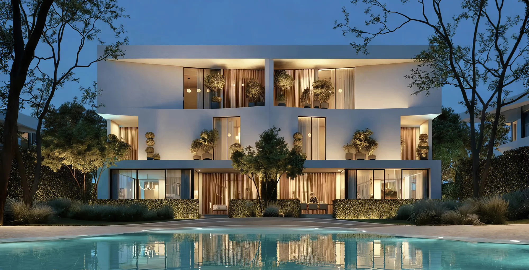 Lagoon-front residences at Lunaya by Zaya lit up at night