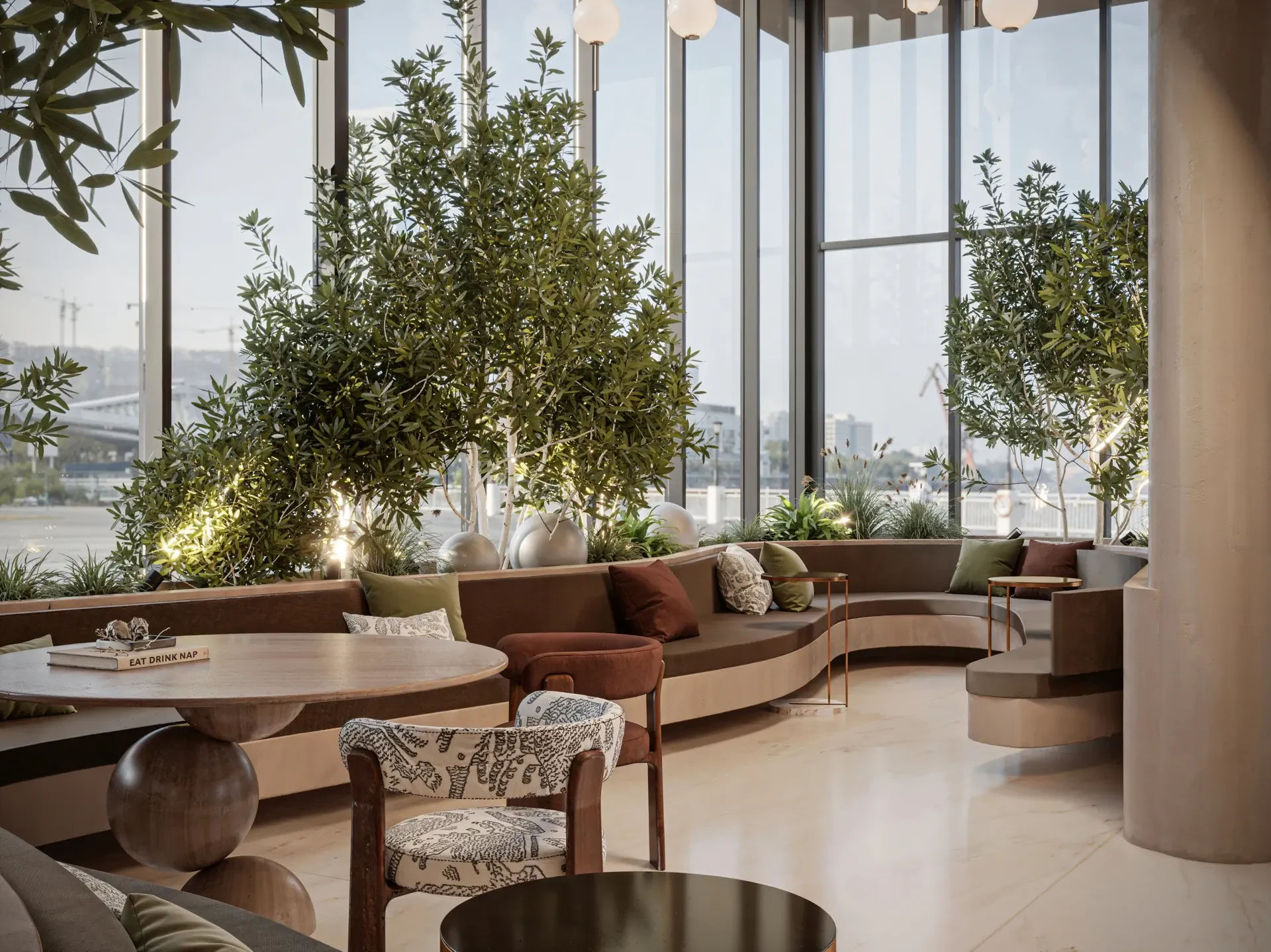 Velora Residence arrival lounge with indoor trees and curved seating, Dubai Islands